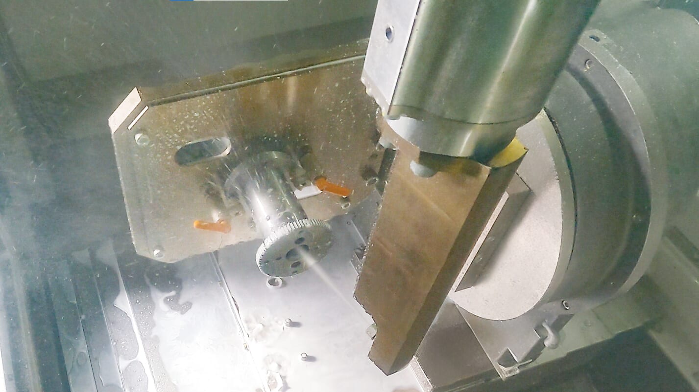 A view inside Sugino's Water Jet Deburring Machine for removing burrs from aerospace, automotive, truck, and engine parts